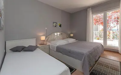Krevet ili kreveti u jedinici u objektu Apartment and Rooms Tatijana