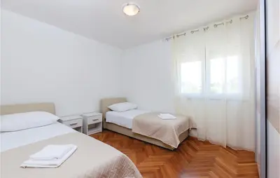Krevet ili kreveti u jedinici u objektu Four-Bedroom Holiday Home In Stobrec