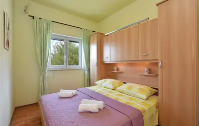 Krevet ili kreveti u jedinici u objektu Six-Bedroom Holiday Home In Podstrana
